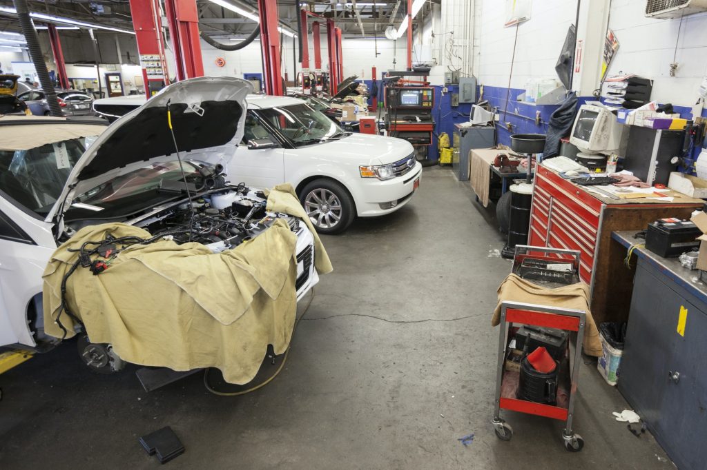 Cars and machinery in an auto repair shop.
